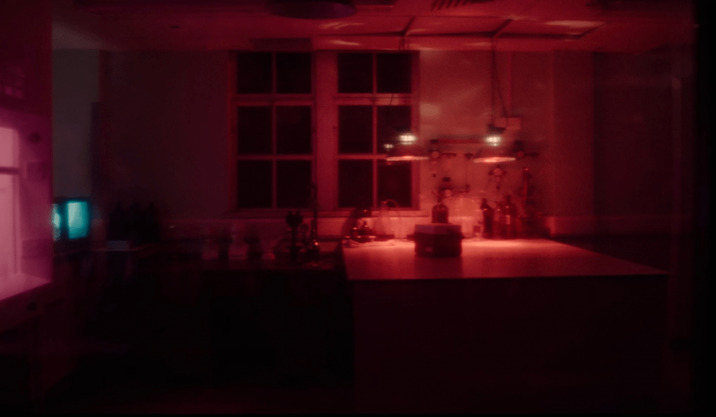 A laborotory style setting bathed in red light.