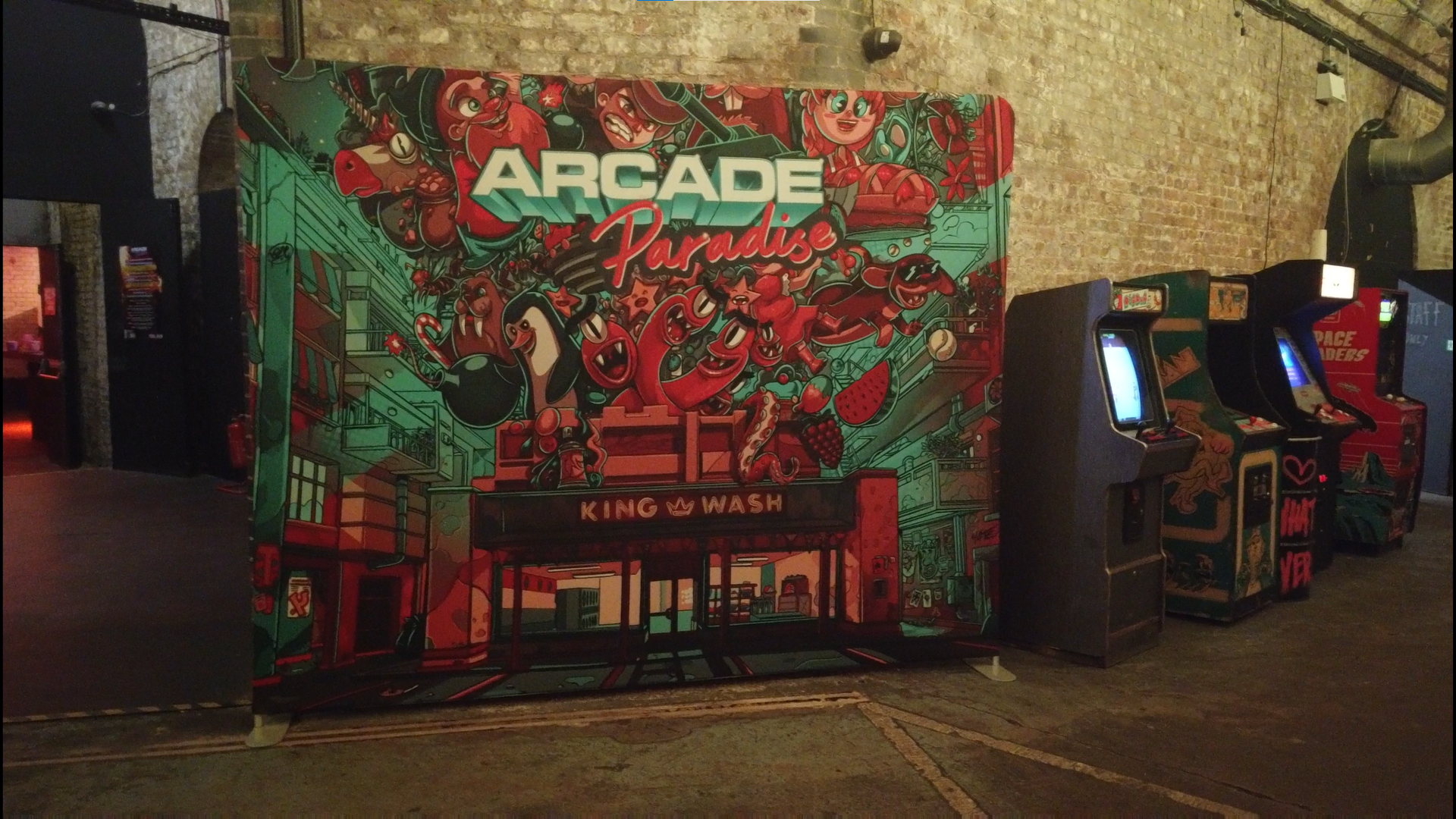 An canvas sheet with Arcade Paradise artwork alongside four retro arcade cabinets