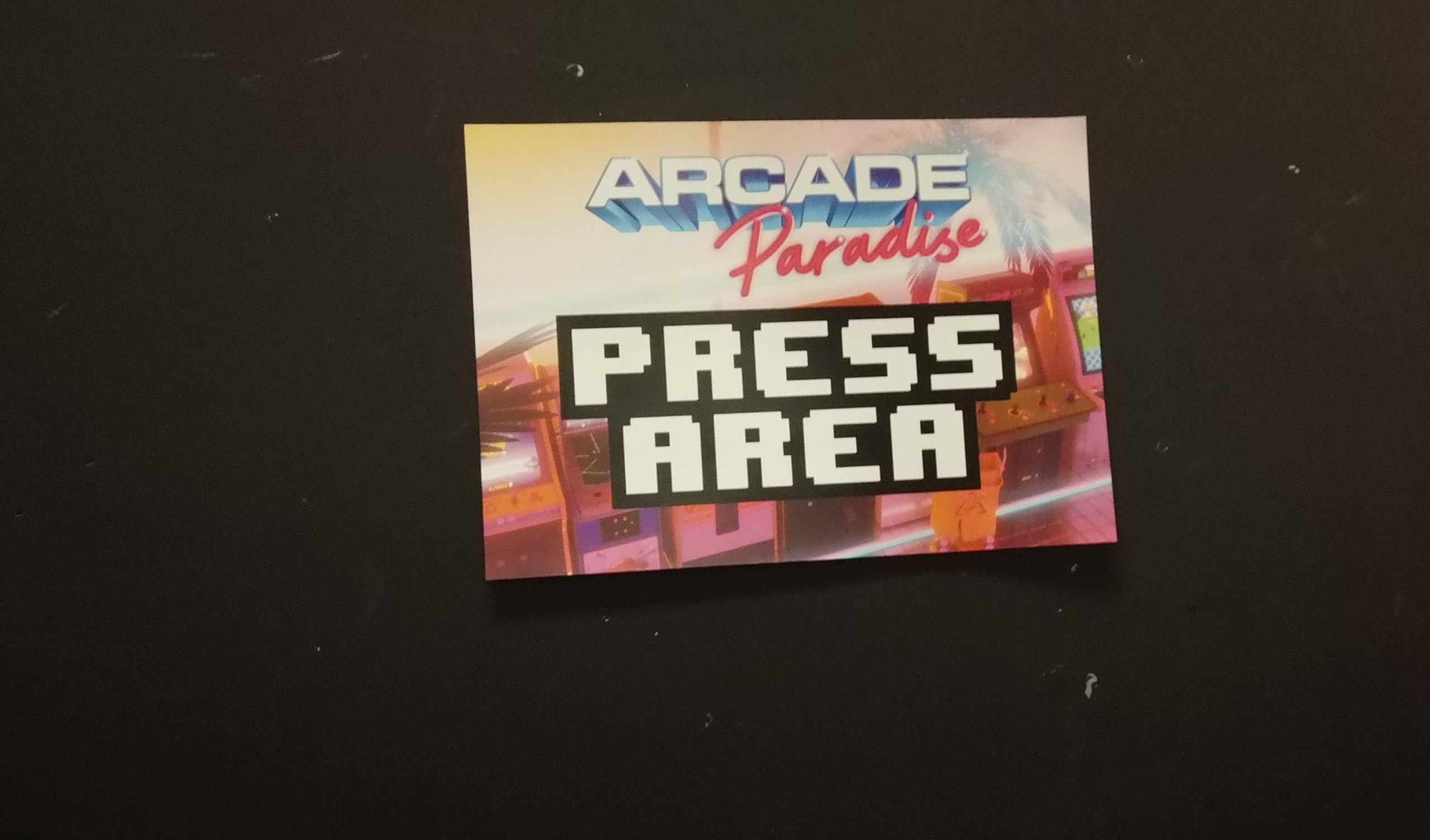 A sign saying Arcade Paradise Press Area