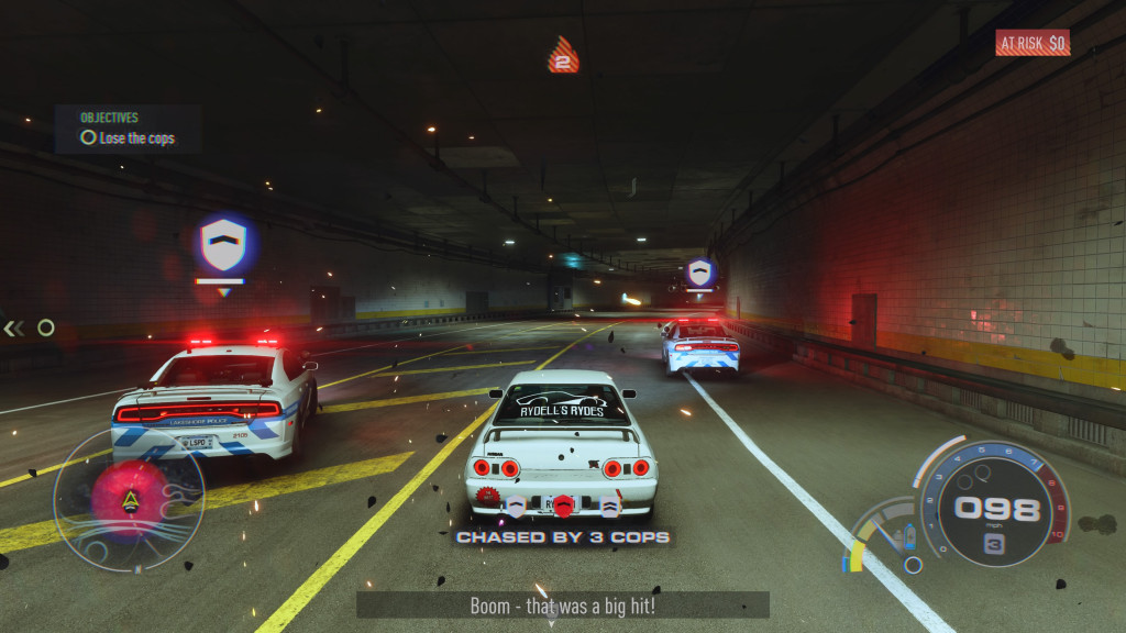 screenshot showing a white car trying to evade 2 police cars in a tunnel