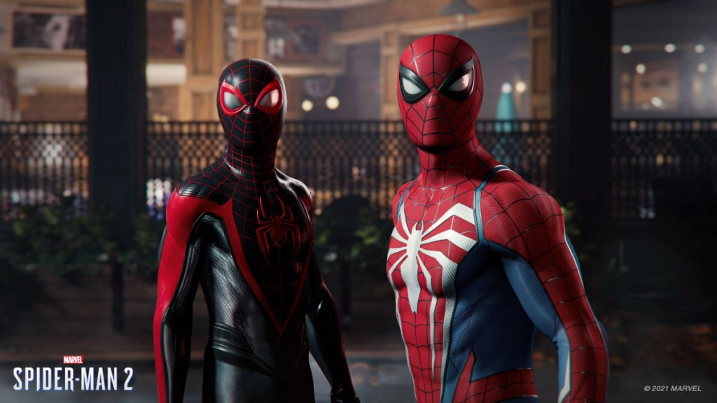 Two spiderman characters look into the camera - one with red, white and blue colouring and the other red and black