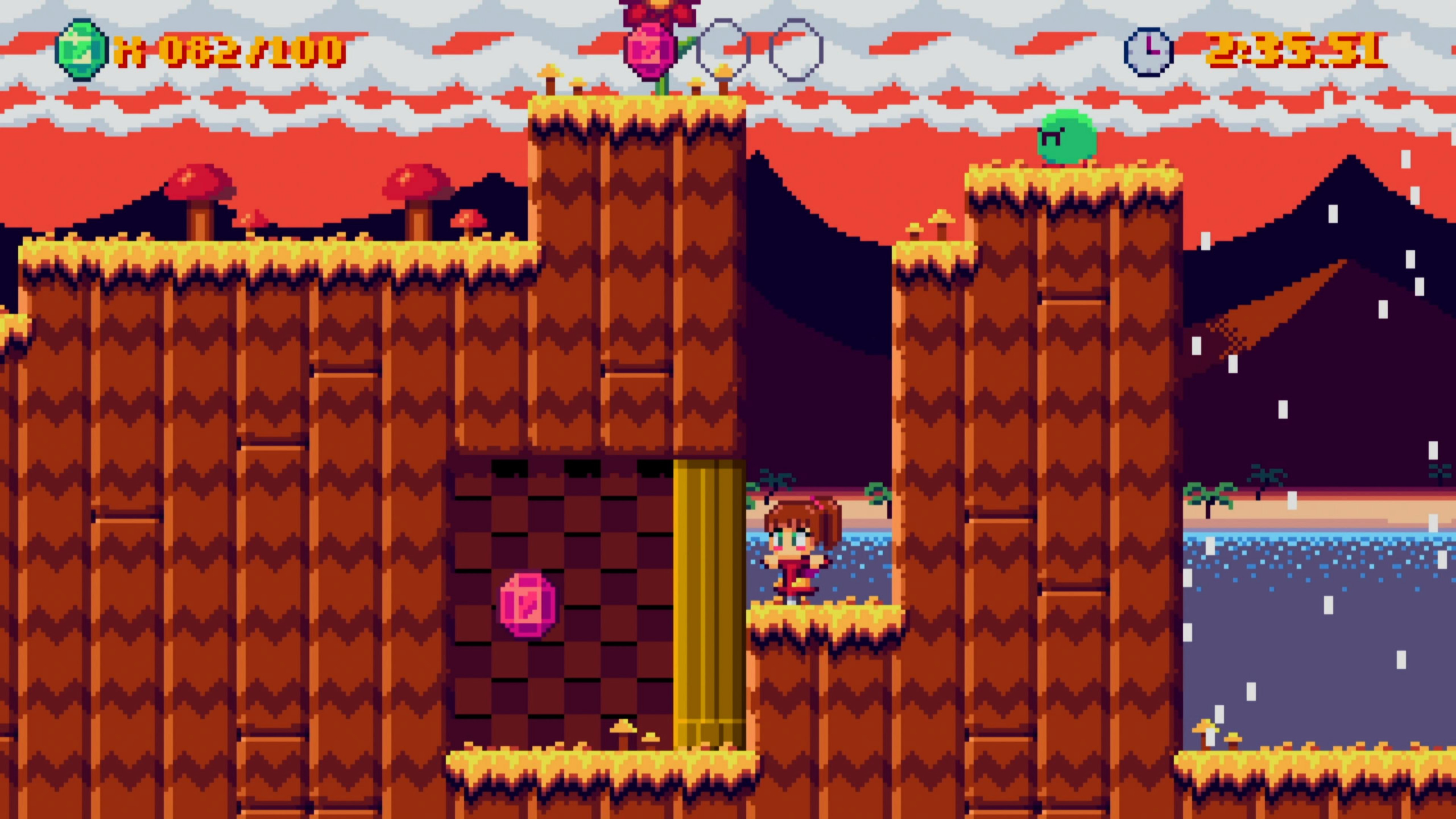 PogoGirl faces a secret area that is locked by a gold pillar which is blocking access to collecting a pink gem. The environment around features brown hills with yellow grass depicting autumn. On top of the hill to her left is a small round green enemy that looks angry