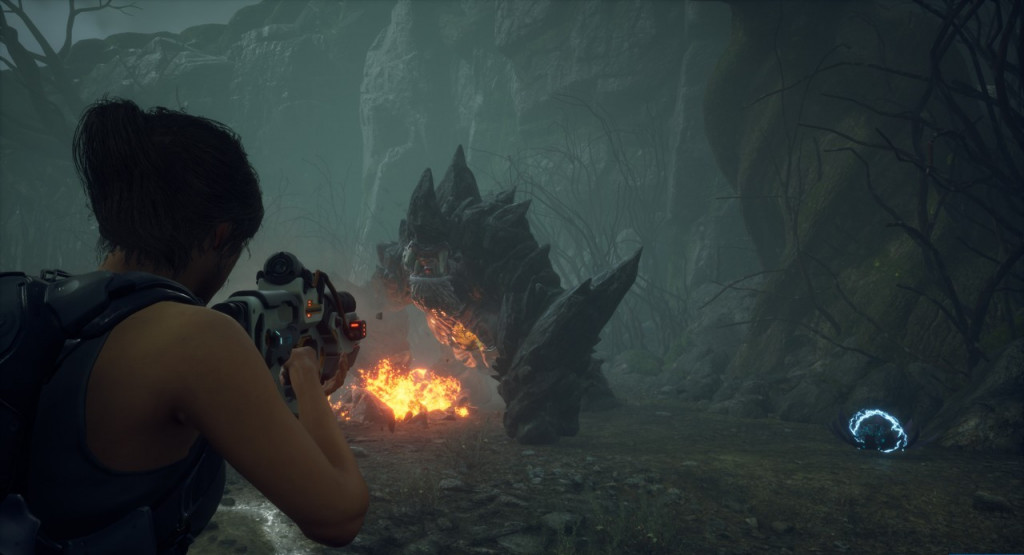Over the shoulder view of the playable character shooting an Incendiary rounds at a large rock covered golem shaped like a gorilla.
