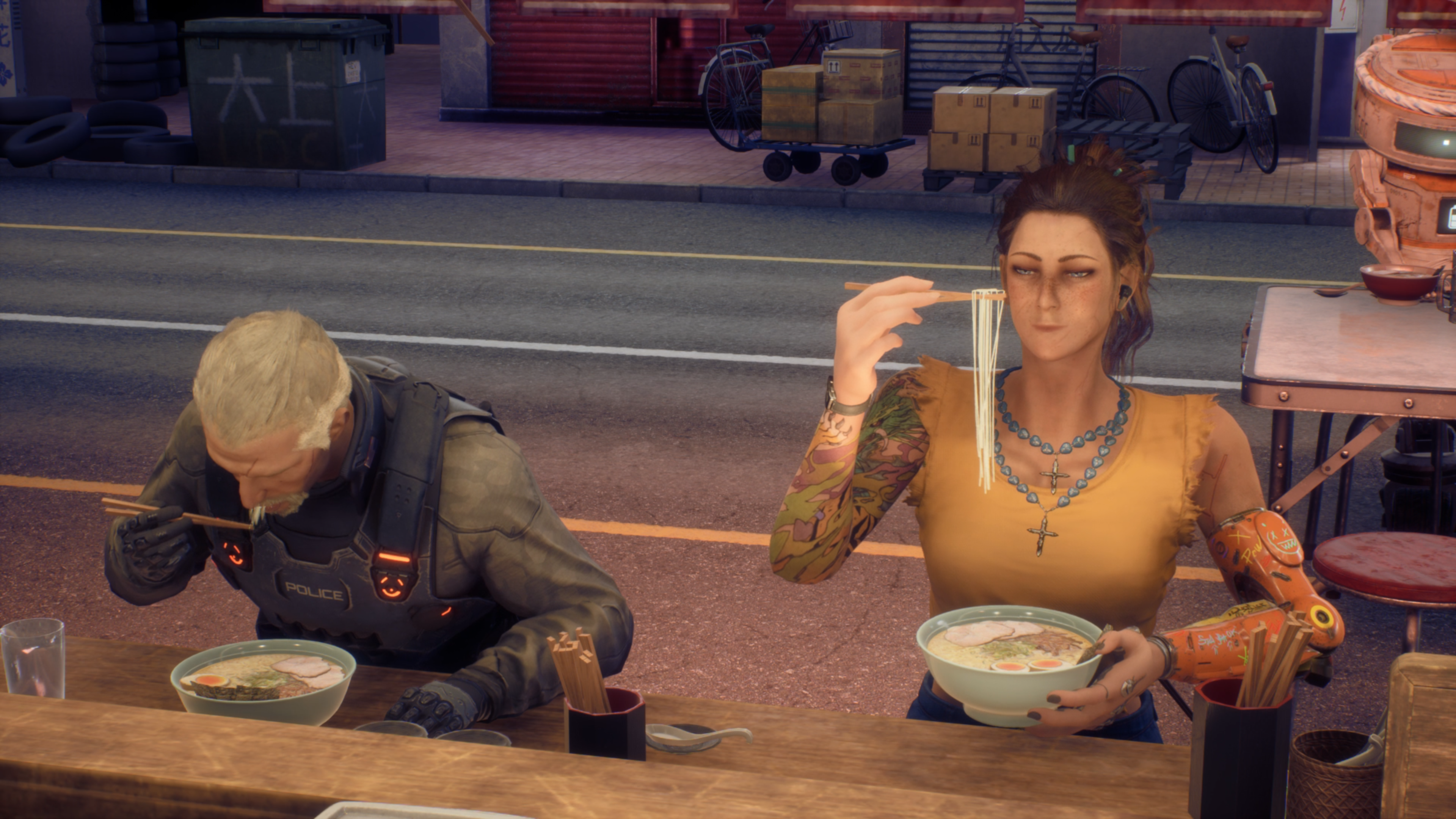 Stone looking hungrily at some ramen in front of her face that she is holding with her chopsticks whilst sat at the Ramen restaurant bar with one of her colleagues.
