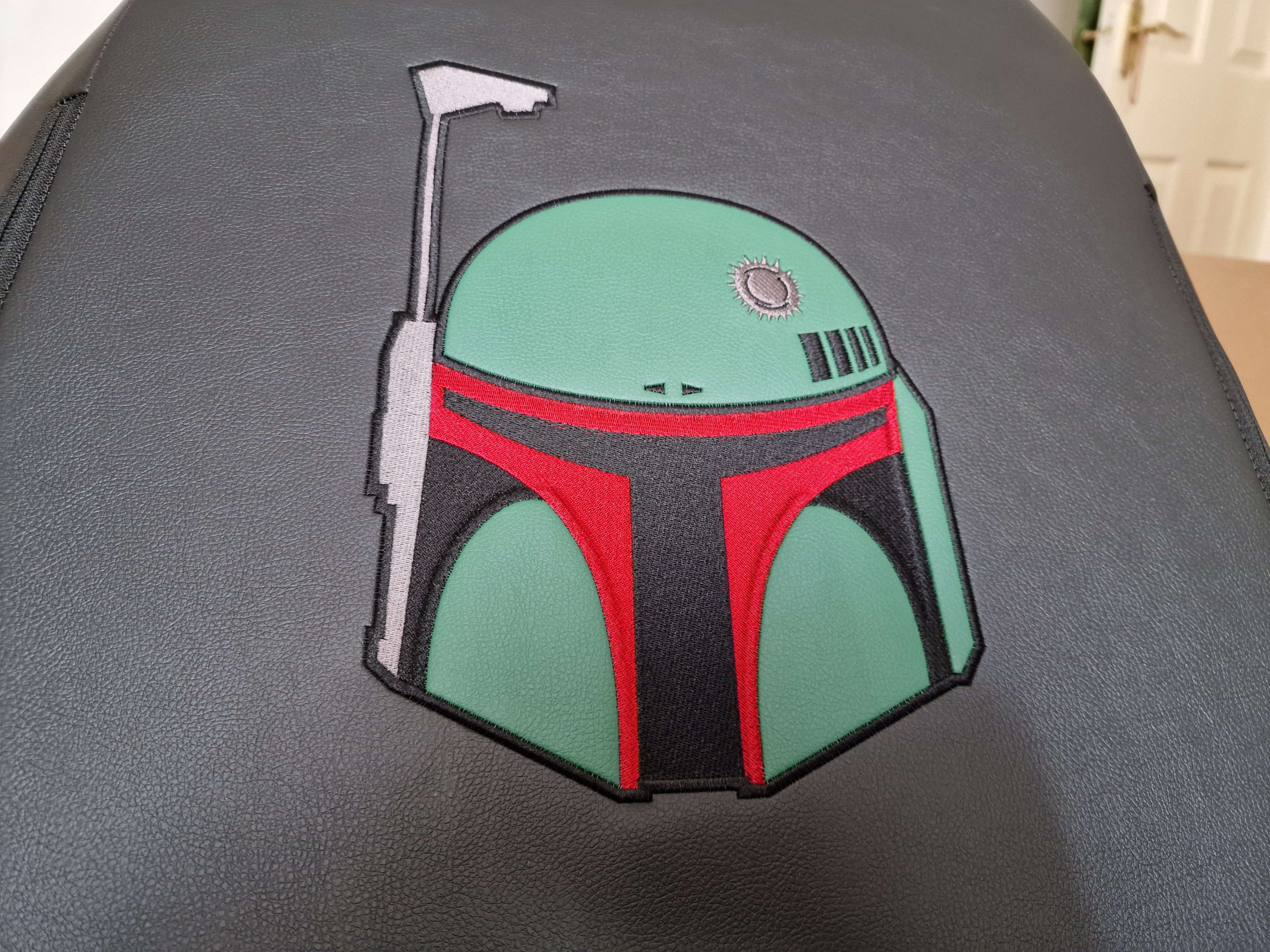 On the back of the chair the embroidered helmet of Boba Fett sits proudly, along with battle mark at the top.