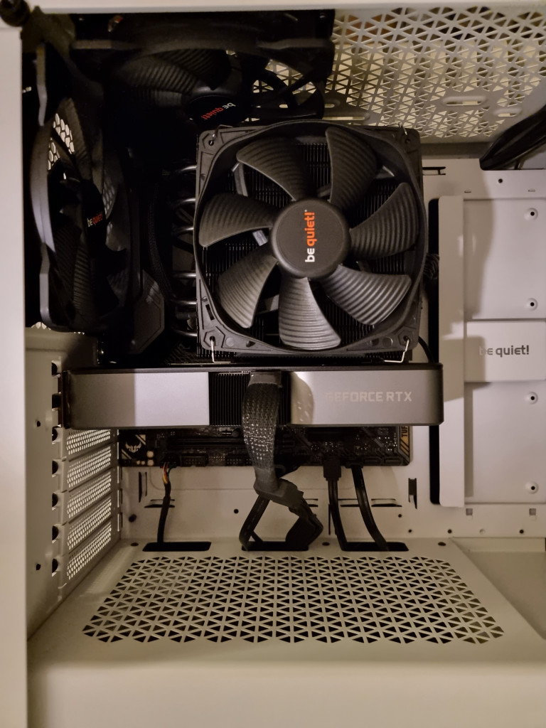 screenshot showing a view into the pc. the mobo, gpu, cpu fan and 2 extract fans can be seen fixed in place.