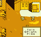 2 pixel art characters stand face to face in front of a brick building with double doors. To the right of the double doors is a vending machine. The bottom right of the image shows a menu with the options - Talk, Fight or Flee. An arrow points to the Fight option