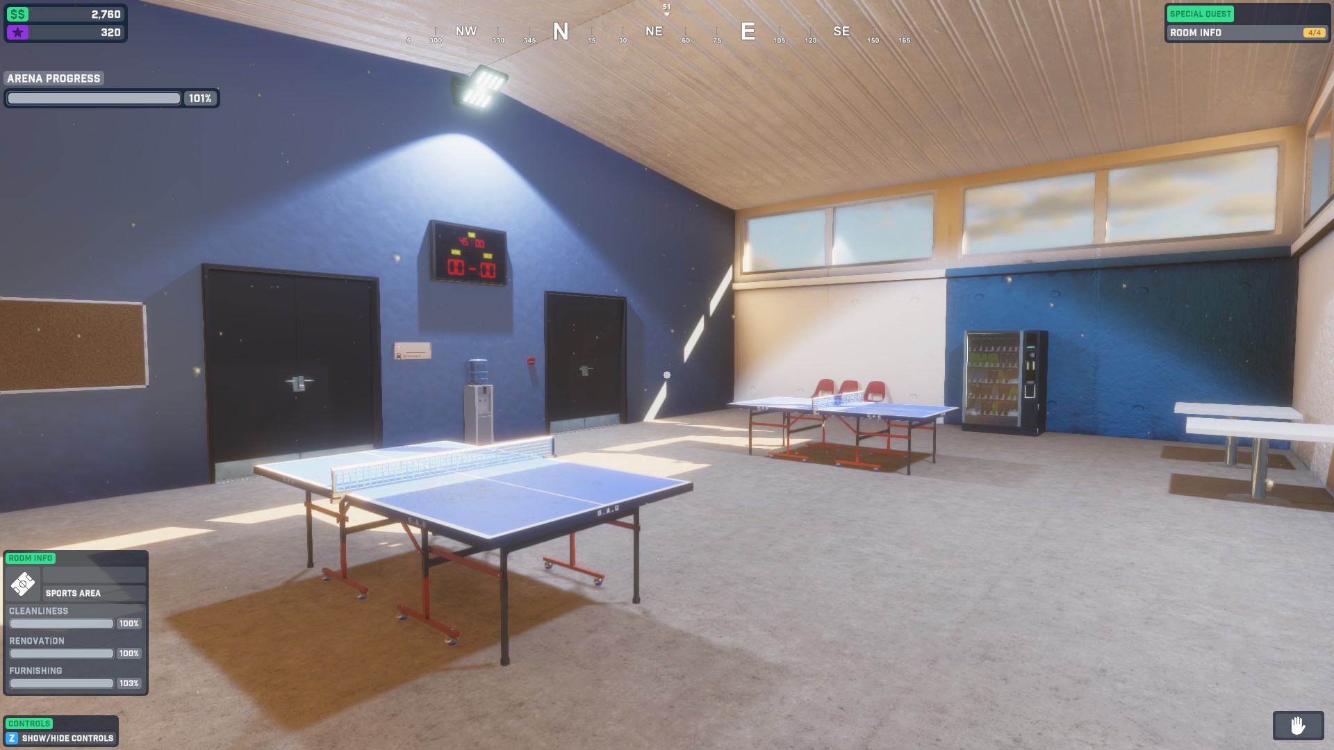 Clear view of a fully renovated room with blue and white walls, two ping pong tables can be seen in the centre.