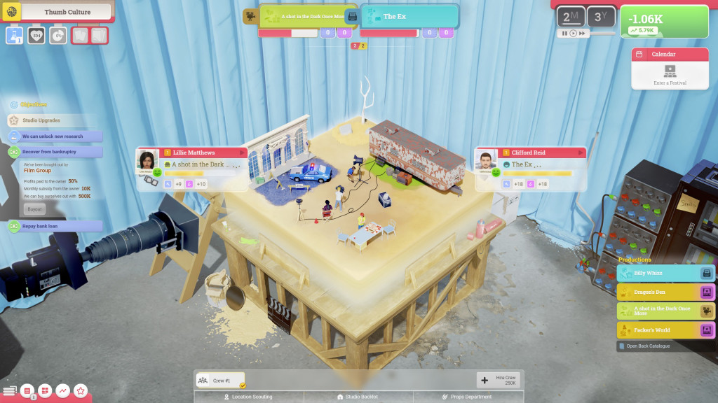 screenshot showing the main view of moviehouse. A diorama with a writer's trailer and production area are shown on an isometric wooden worktop.