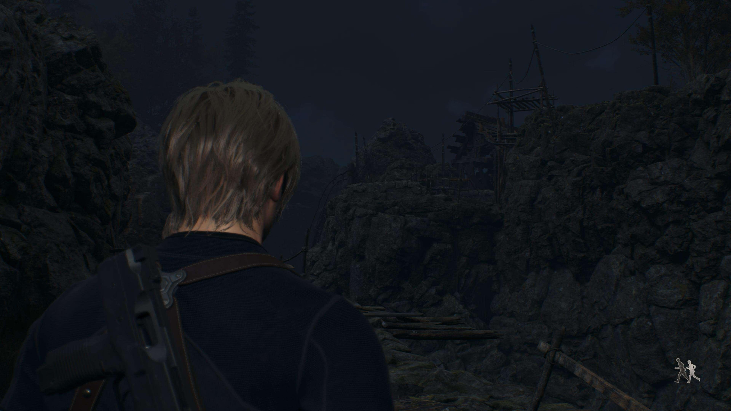 Leon Kennedy stands in front of a dark cliff, overseeing the damage that has been caused