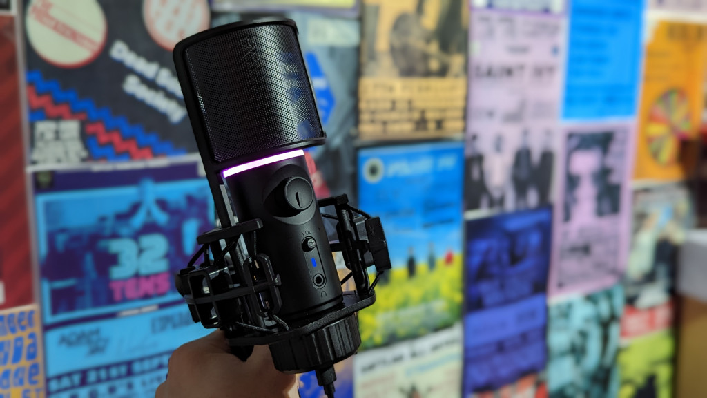 A microphone held in front of a colourful blurred background
