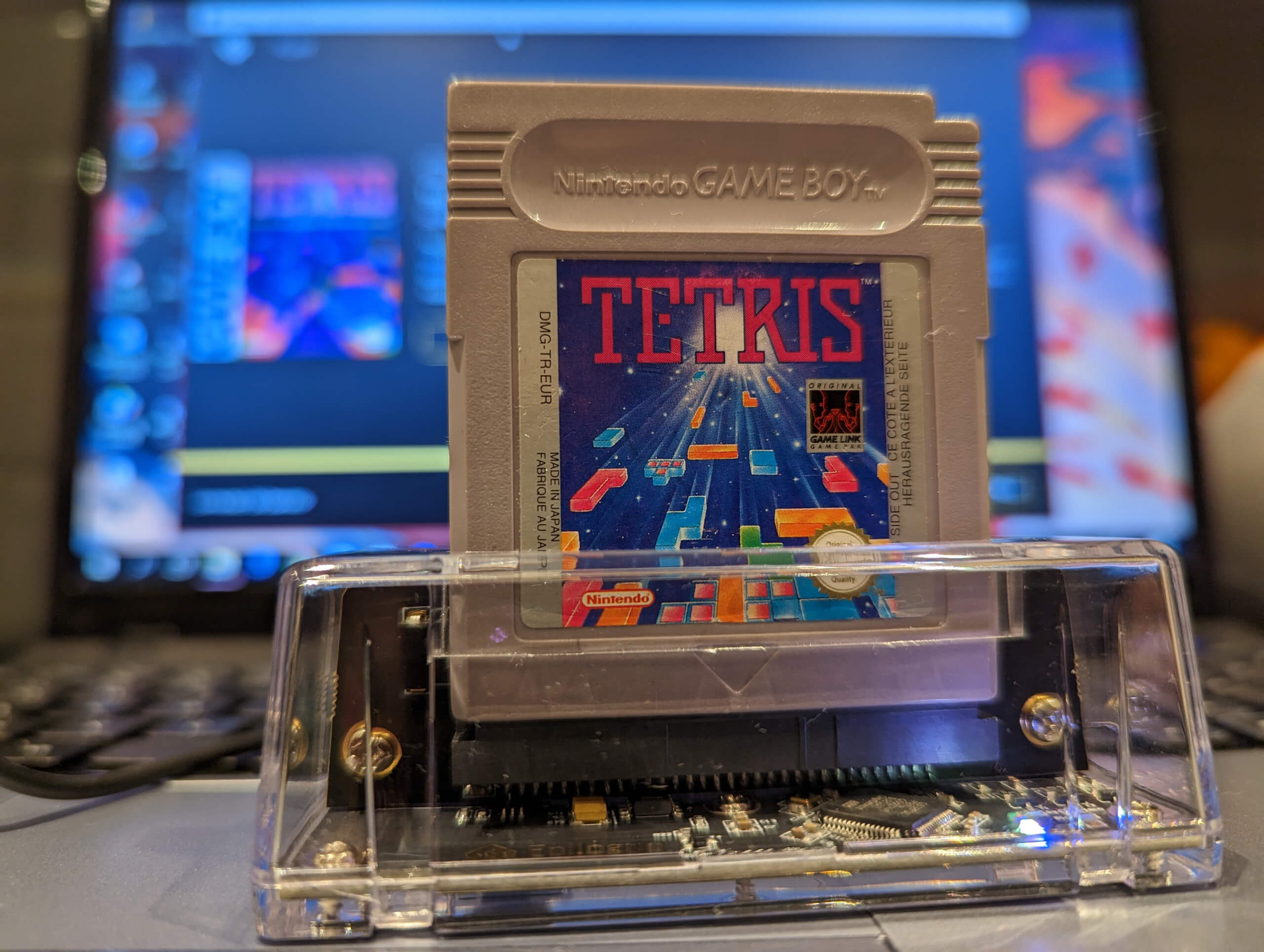 close up of the GB Operator in operation with a Tetris cartridge inserted. A small white led inside the device shows that its powered on
