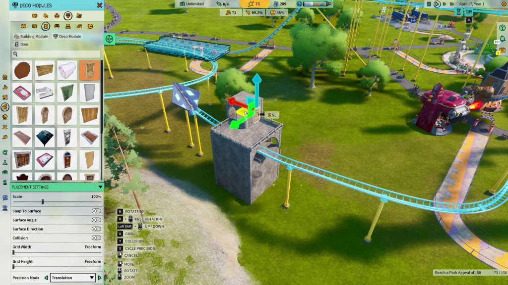 screenshot showing a decorative module being installed for a roller coaster. It is a grey stone structure that has the light blue track sailing through a gap in the middle. The track is supported by yellow stilts and is on green grass.