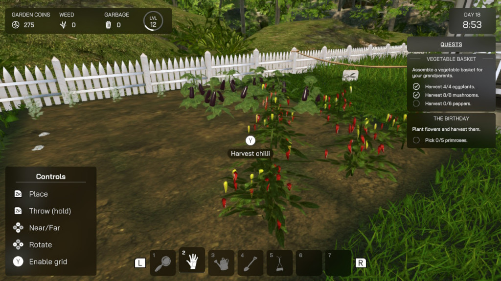 screenshot showing a vegetable patch. Once more surrounded by a white picket fence and green grass. Red chilli's with green leaves are ready to harvest. Purple aubergines hang from the plants behind them. 