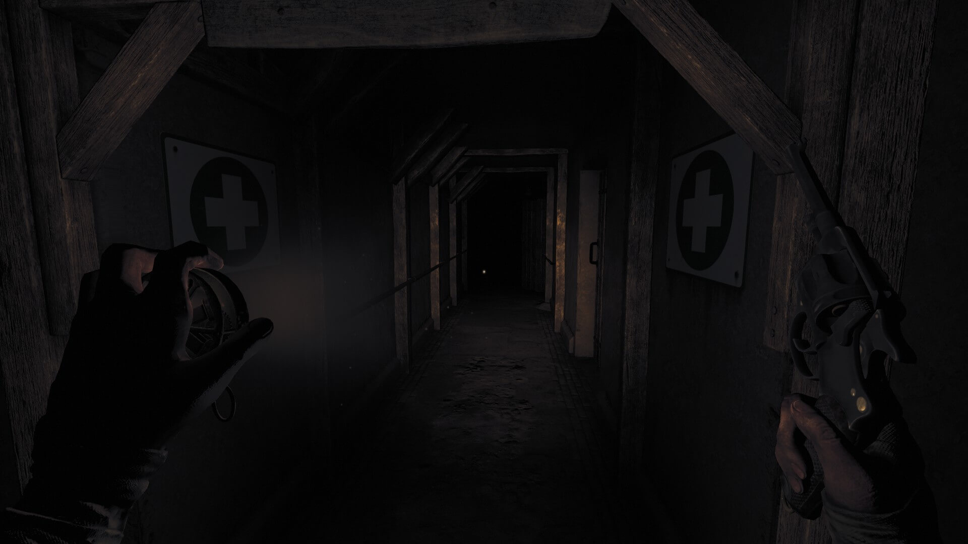 A pitch-black corridor with two medical signs on either side. I am equipped with a wind up flashlight and my trusty revolver as I journey deeper into the bunker.