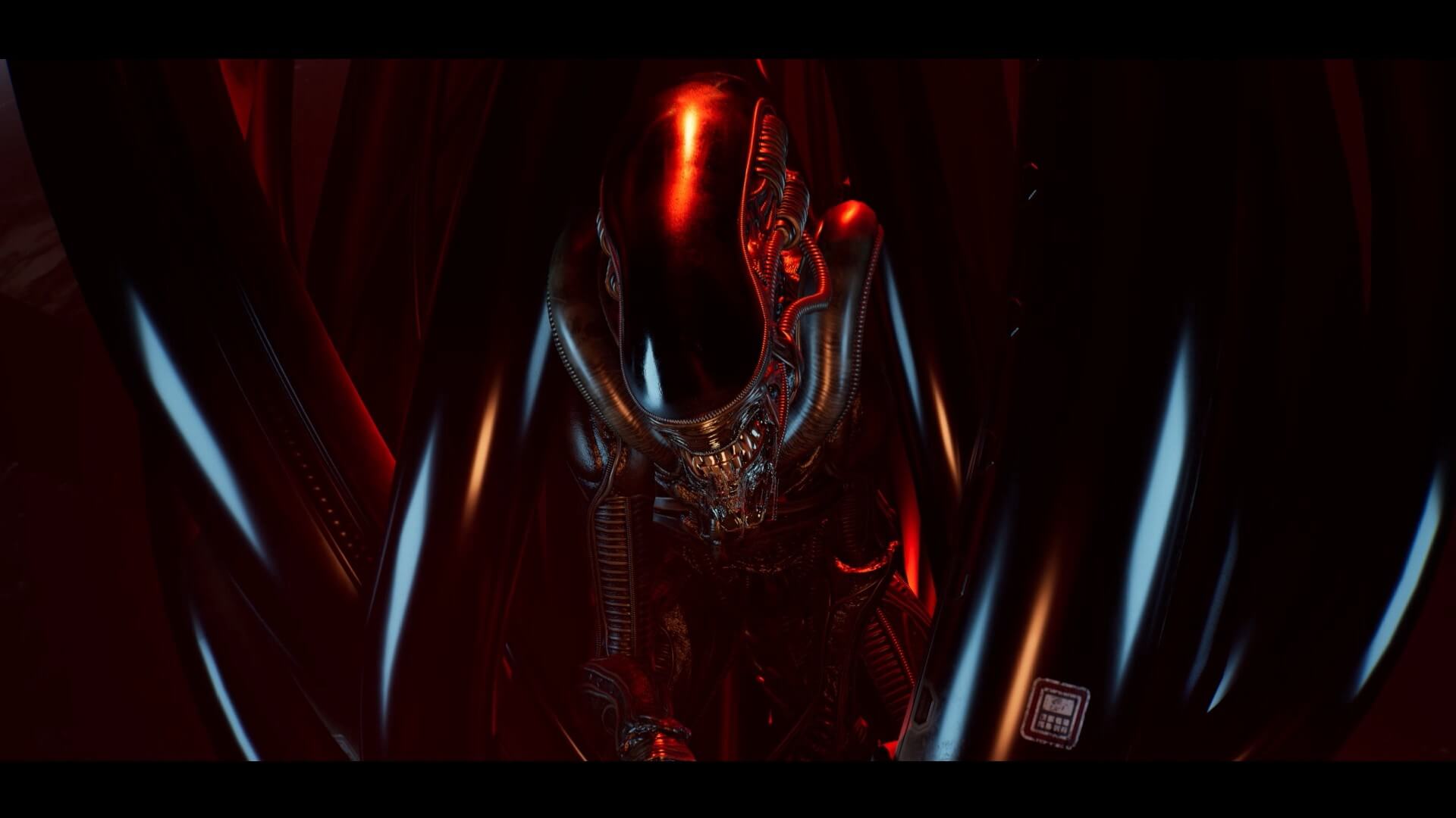 A red tint on the xenomorph hiding amongst some large rubber tubing above a computer is a tactic Xenomorphs are commonly known to use for hiding.
