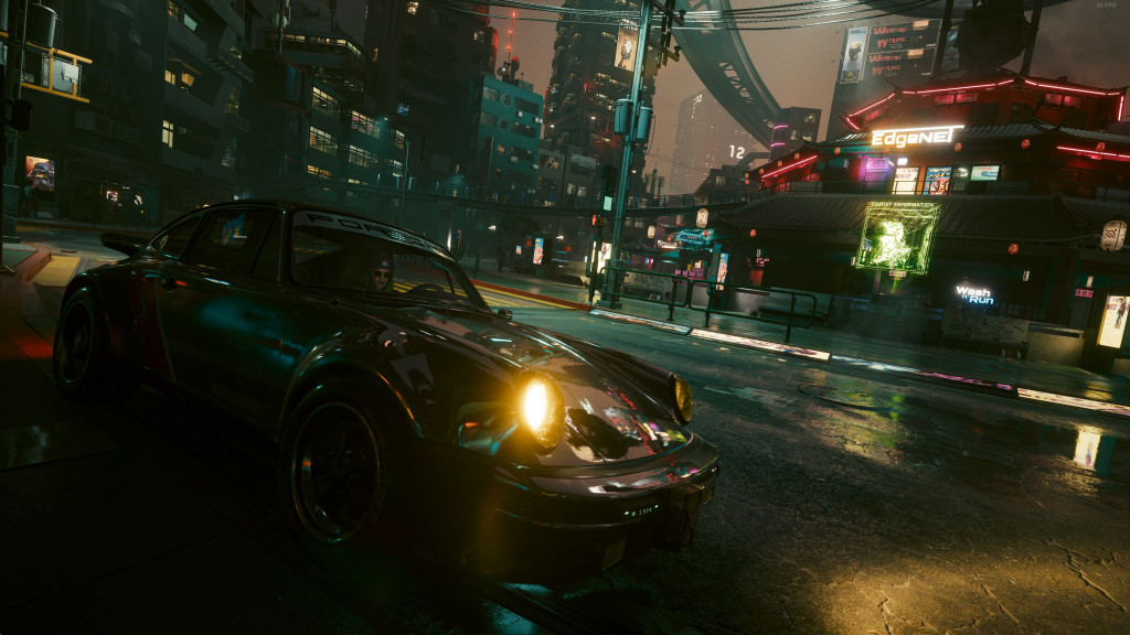 A screen shot from Cyberpunk 2077 showing V sat in a Porsche 911 II (930) with Ray Traced reflections.