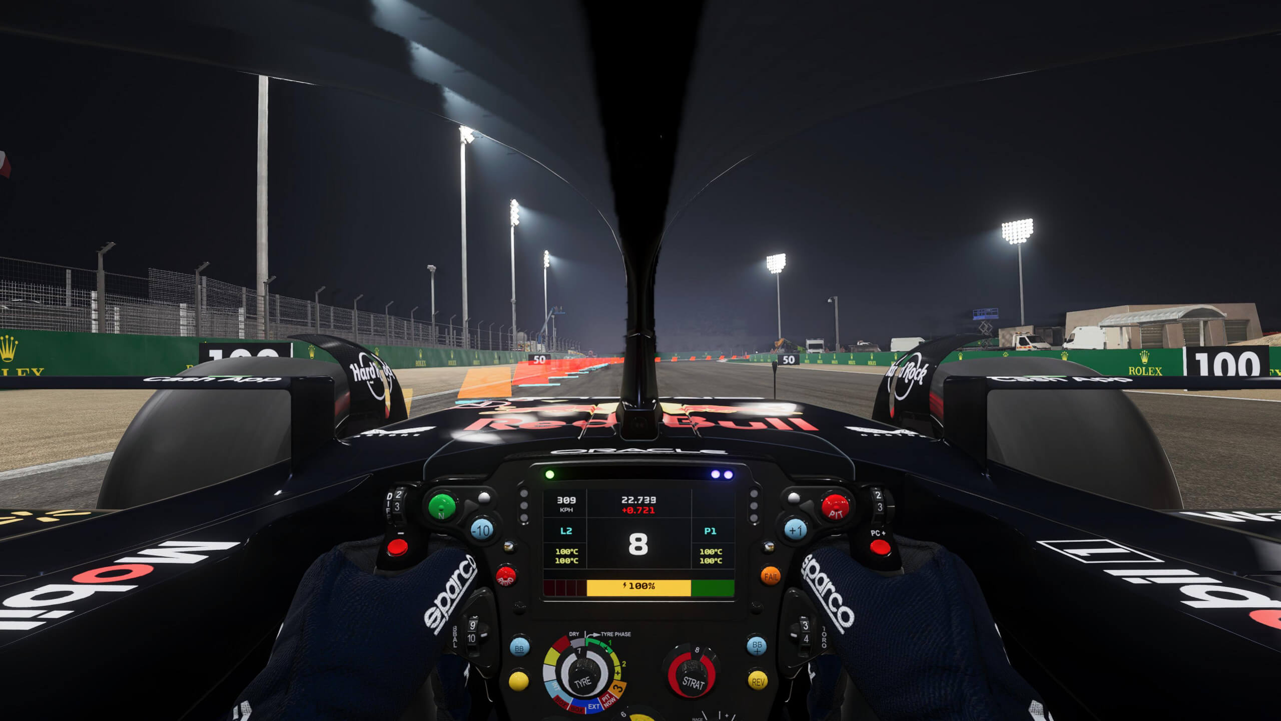 Cockpit view from inside the F1 23 Redbull car racing at night as floodlights illuminate the track