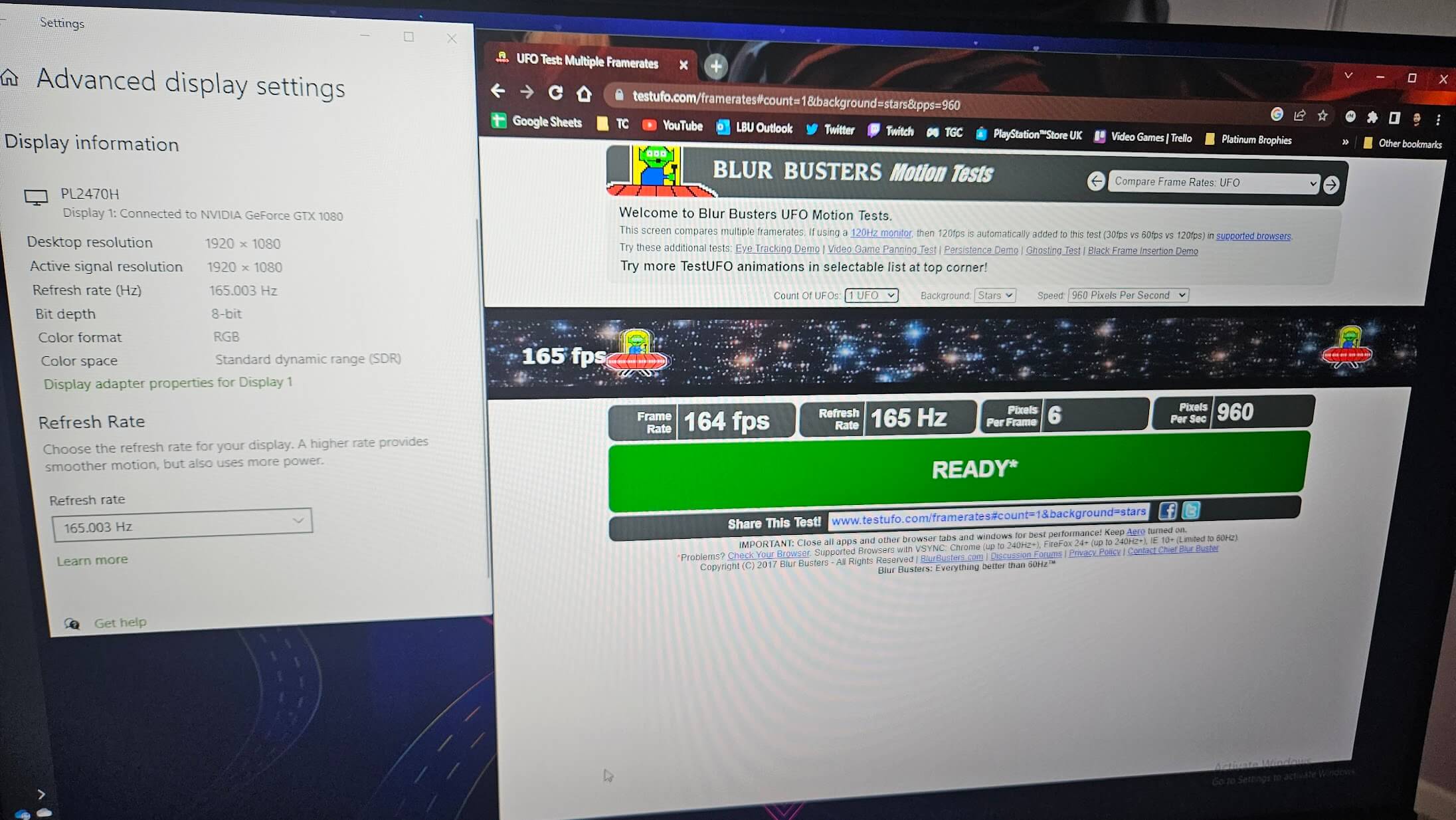 Picture of the monitor with the results of a motion test performed on testufo.com. The frame rate shows 164fps.