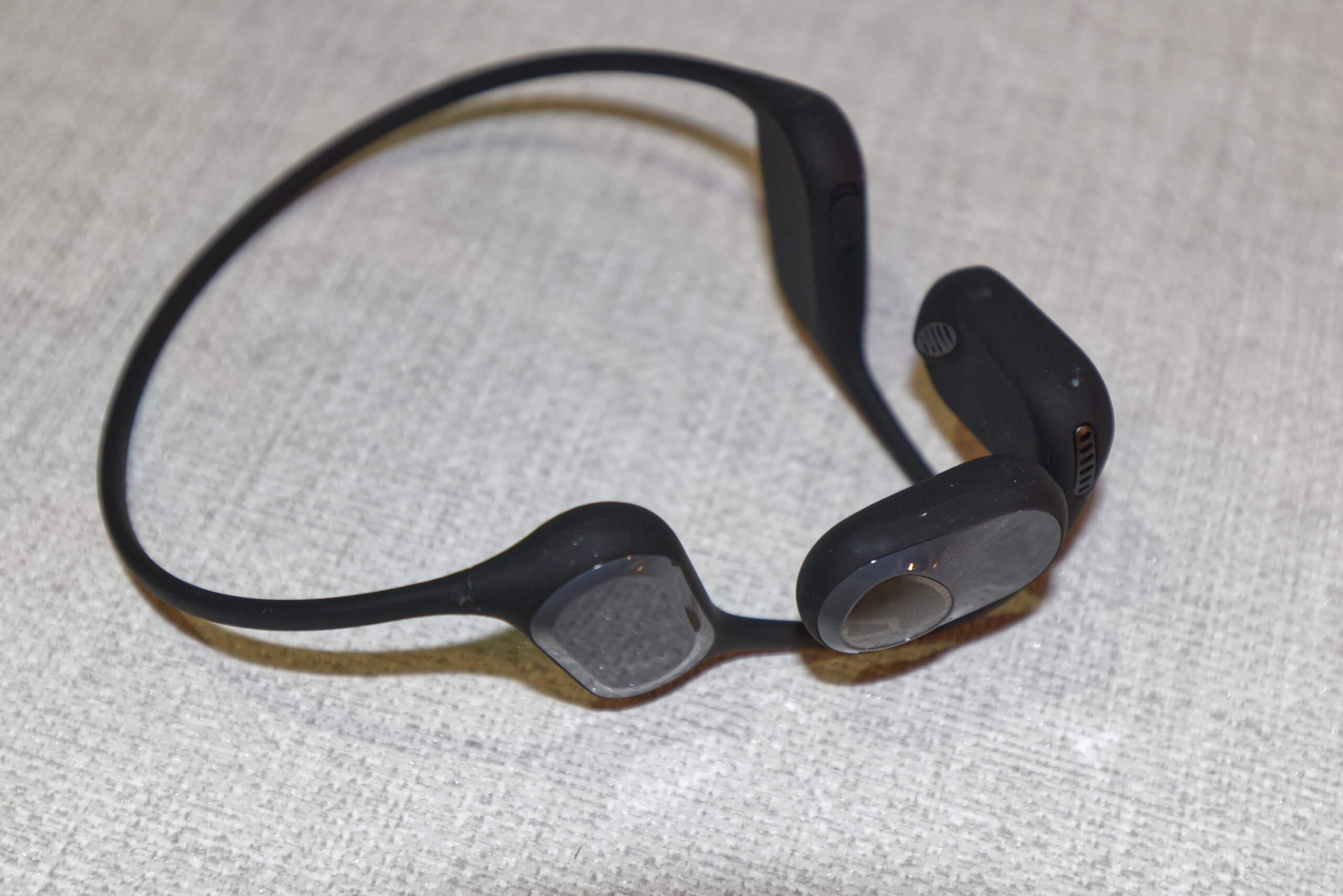 Photo of the SoundPeats headphones by themselves, showing the headband. The headphones are black with grey highlights, and the silicone headband is black all round