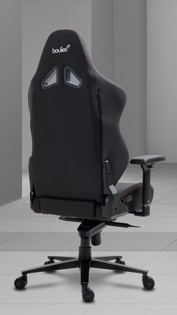 The back of a black Ninja Pro Chair in a white room