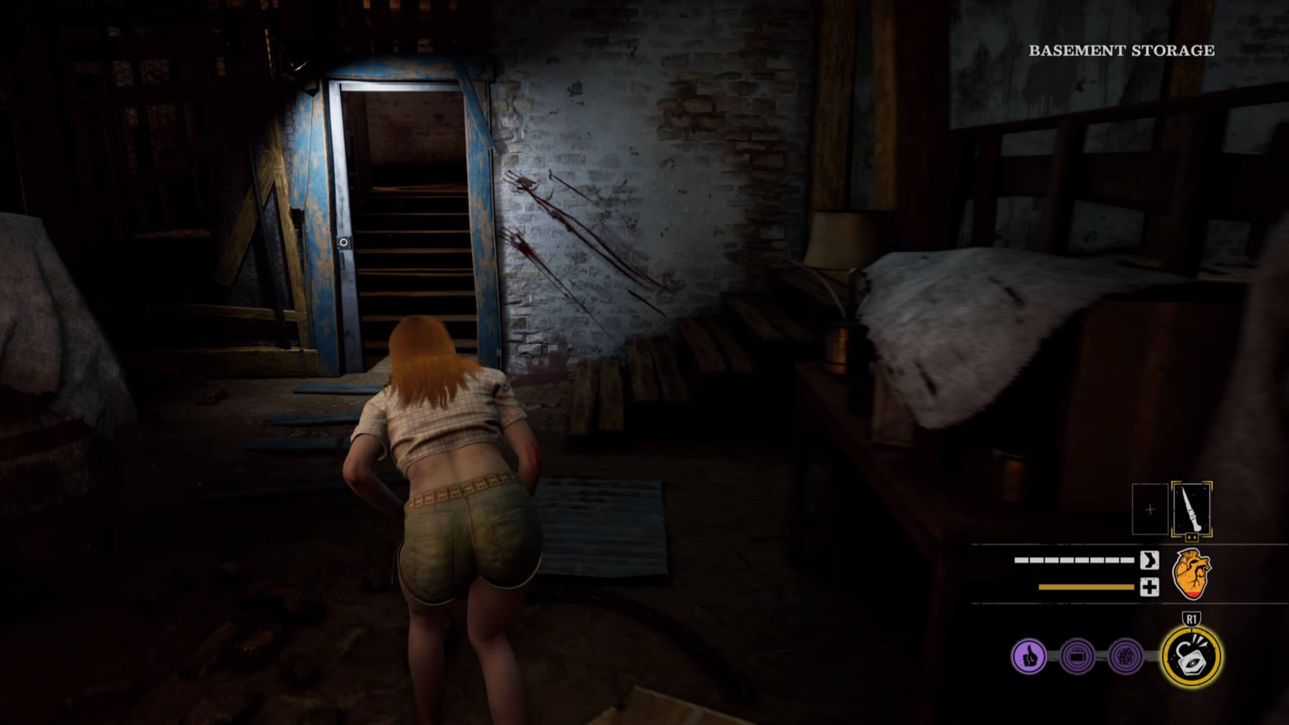A dark basement, with a door that has been unlocked leading to a set of stairs. Connie who is one of the Victims slowly sneaks towards the stairs through the dark.
