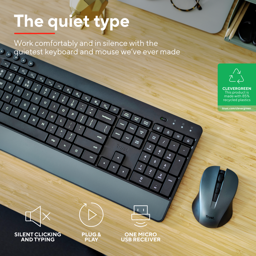 Black keyboard and mouse set on a wooden desk. Text: The quiet type. Work comfortably and in silence with the quietest keyboard and mouse we've ever made. Clevergreen. This product is made with 85% recycled plastics. Silent Clicking and Typing. Plug & Play. One Micro USB Receiver.