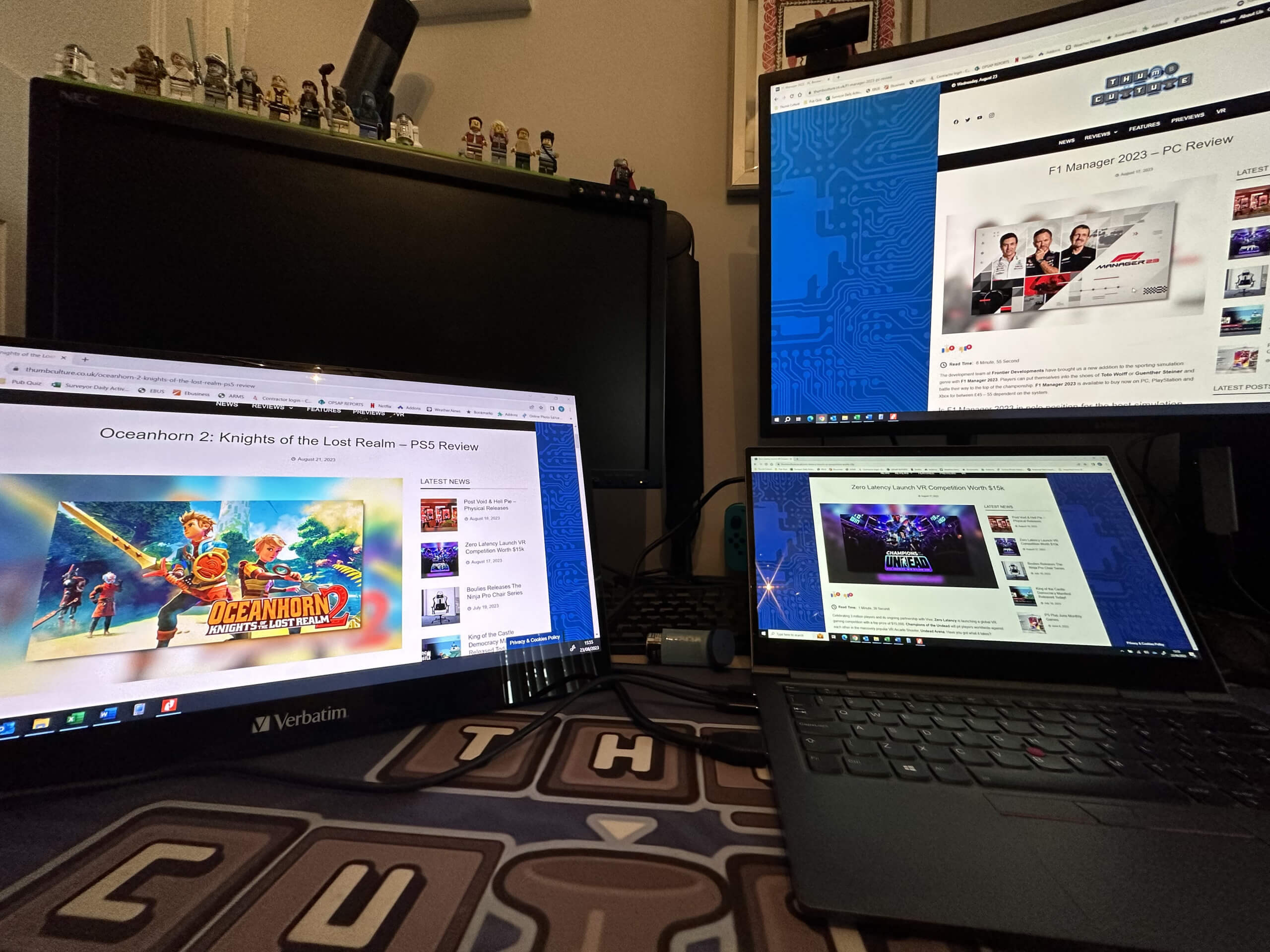 This image shows the verbatim pmt-17 next to a laptop that is also outputting to the monitor on the right side of the screen. each screen showing a different Thumb Culture review.