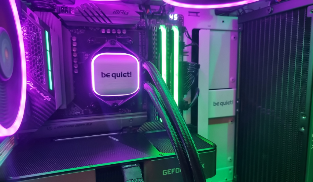 photo showing the full be quiet! aio running inside the pc case. the 3 exhaust fans are lit in purple along with the cooler block. The memory is lit in neon green along with the motherboard to compliment.