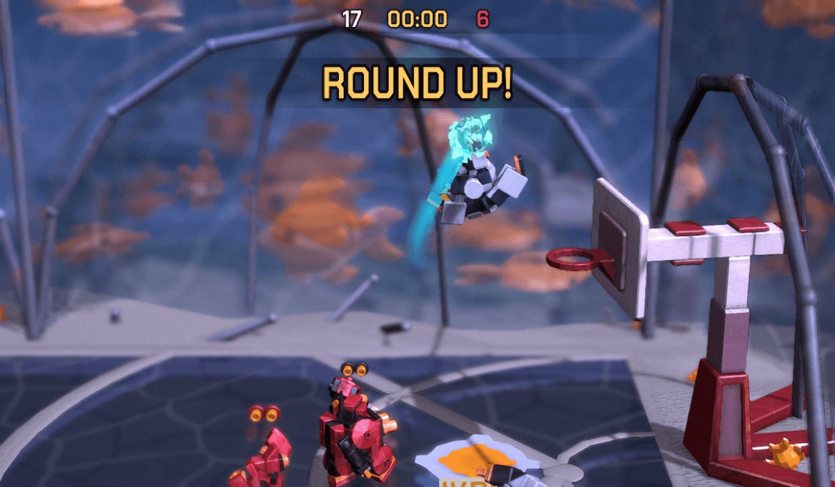 A white robot is mid-dunk, but the round is ended with a large "ROUND UP!" sign overlayed on the action. The background shows large fish behind frosted glass - an odd backdrop for a basketball game!
