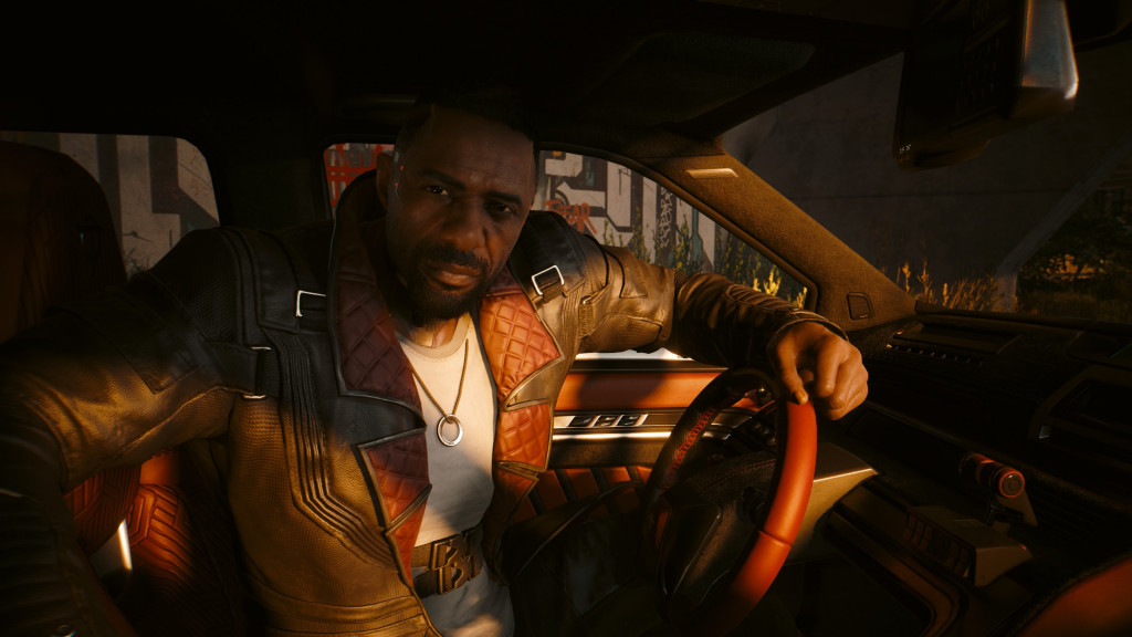 A character looking much like Idris Elba sits in the drivers seat looking at you intently