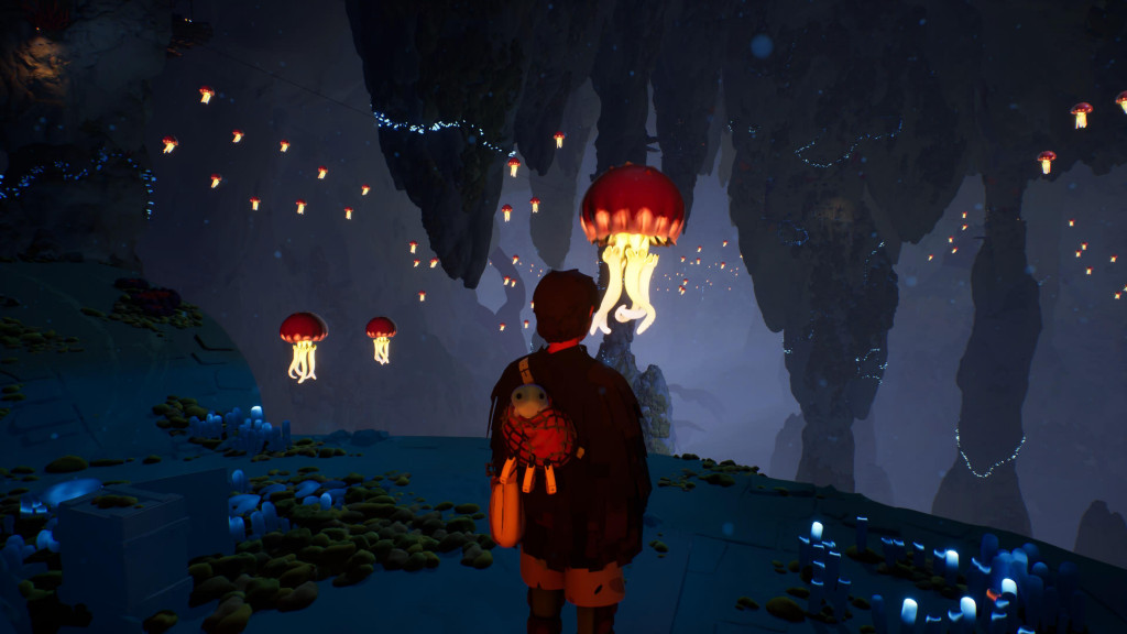 The player character is stood in a vast, dark cavern. Large stalagmites and stalactites stretch from the ceiling and floor. Big jellyfish like creatures litter the space between floating in the air. They have dark orange bodyies with light, yellow tentacles. 