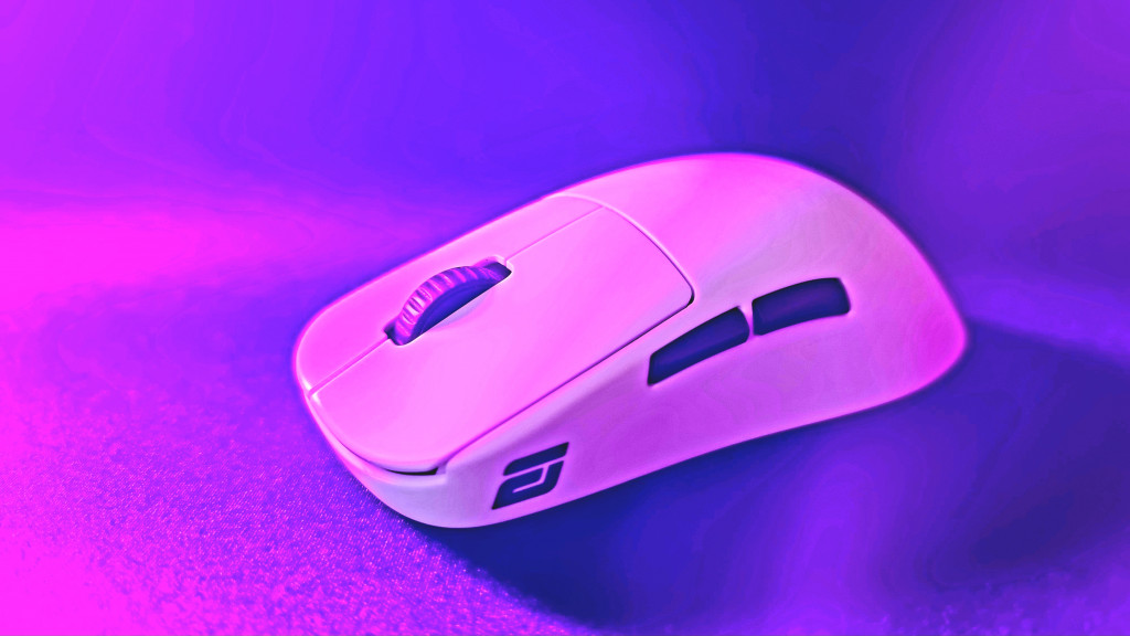 photo of the white endgame gear gaming mouse with the camera looking at an angle towards it. The white of the mouse is contrasted by the black middle wheel on top and 2 side buttons. The endgame gear logo can be seen on the side as well. The mouse is bathed in purple light.