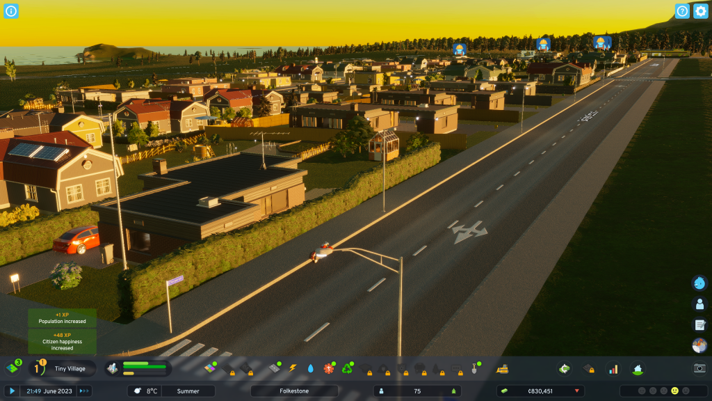 screenshot showing dawn in my city. The skyline is yellow and the camera is looking along a road that has small residential buildings along one side.