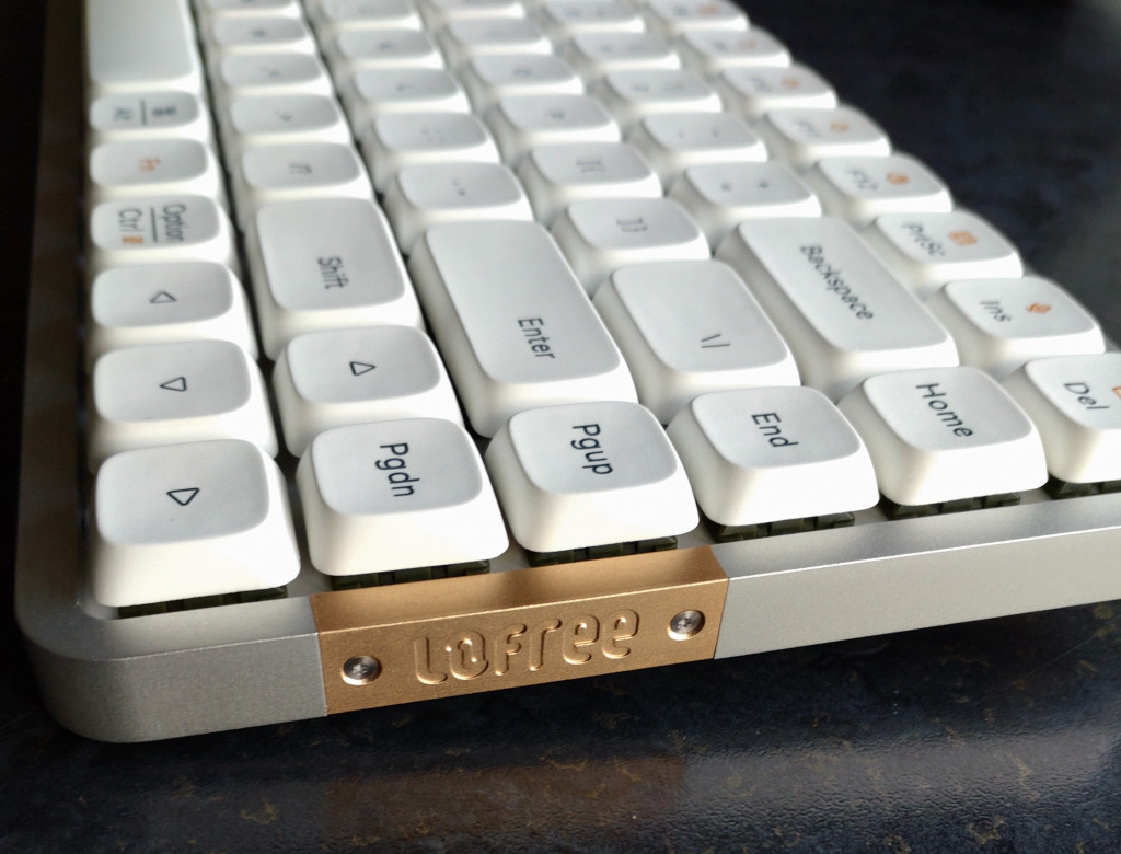 The side view of the Lofree keyboard. The sides are silver with a copper-coloured section. The word Lofree is embossed into the copper section.
