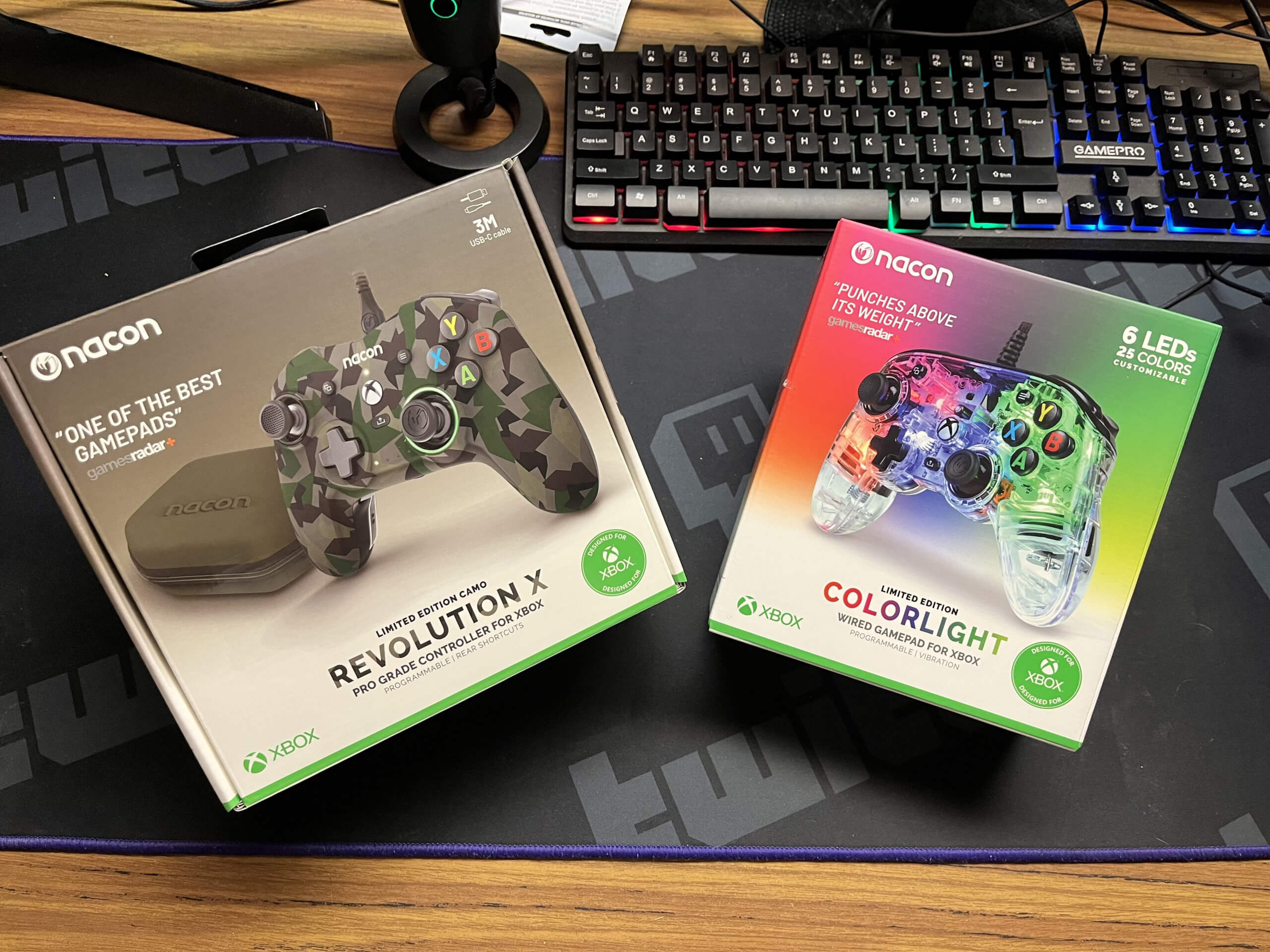 A box on the left with the Nacon Revolution X Pro in limited edition camo and the Nacon Pro Compact Colorlight on the right. The Colorlight box is very colorful whereas the Revolution X box is muted.