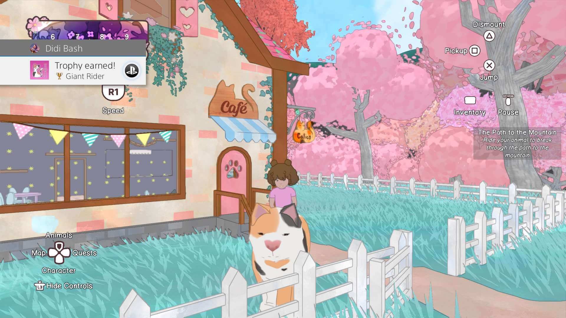 My character mounted on a large tabby cat named Pudgems. Stood in front of the cafe. You can see cherry blossom and the grassy field as well as the entrance to the cafe. 