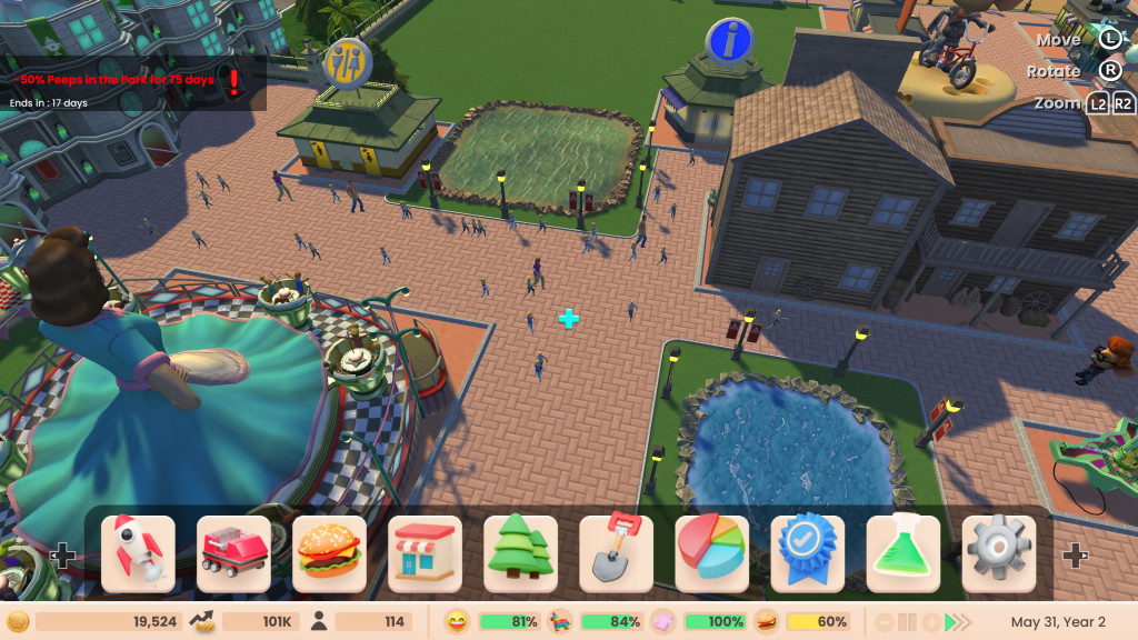screenshot showing the park with brown block paved paths, a small blue pond and a tea cup ride. There is a wc and wooden-clad wild west restaurant present.