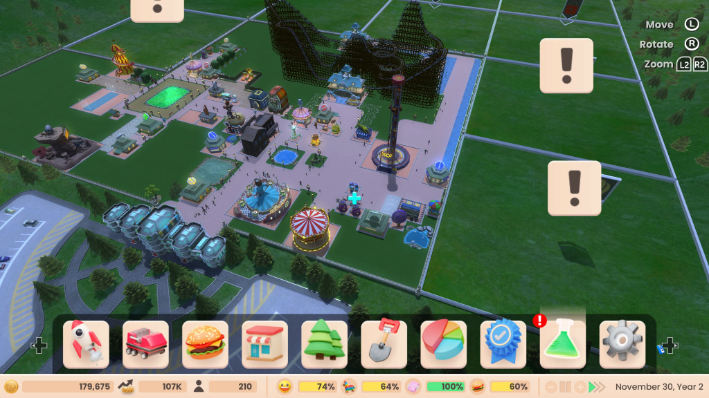 screenshot showing a zoomed out view of the park. It is a green grassland with buyable square areas available for expansion indicated by a hovering exclamation mark sign. In the centre is my park with several rides, pink paths and a large wooder rollercoaster towards the back.