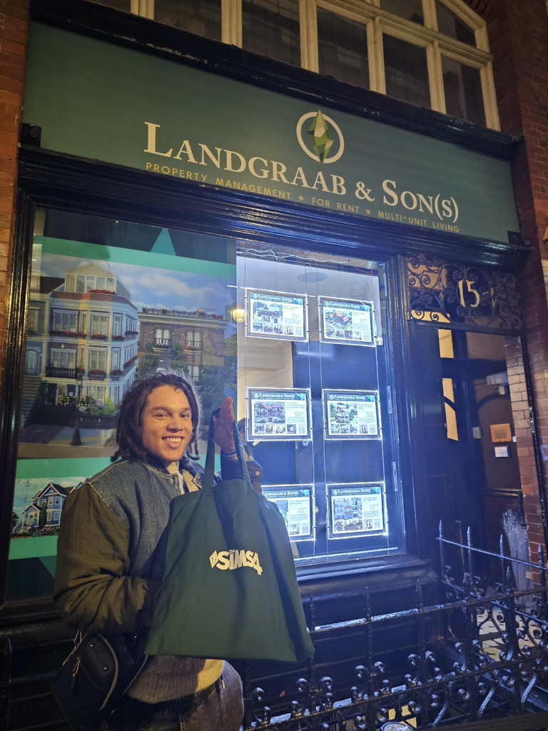 Standing outside of The LandGraab & Son(s) realestate agent. A pop up store brought from the world of The Sims 4 into real life