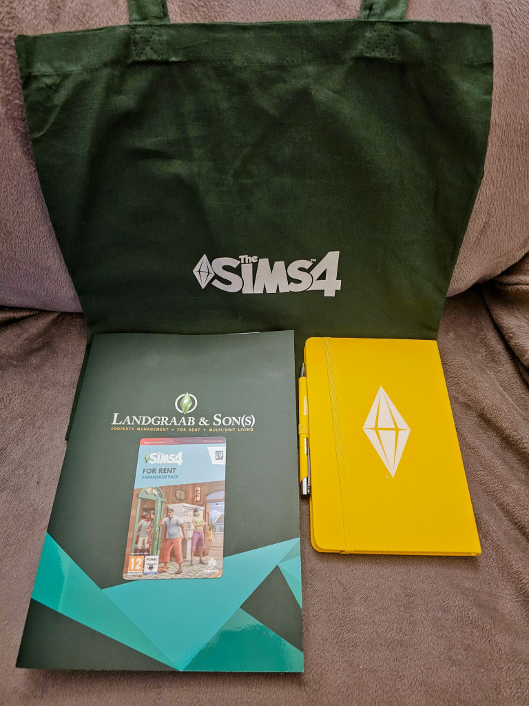 The Sims 4 Green Tote Bag, a yellow notebook with The Sims logo, a card for The Sims For Rent Expansion, and a Landgraab and son(s) brochure 