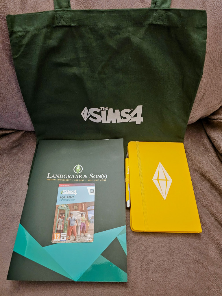 The Sims 4 Green Tote Bag, a yellow notebook with The Sims logo, a card for The Sims For Rent Expansion, and a Landgraab and son(s) brochure