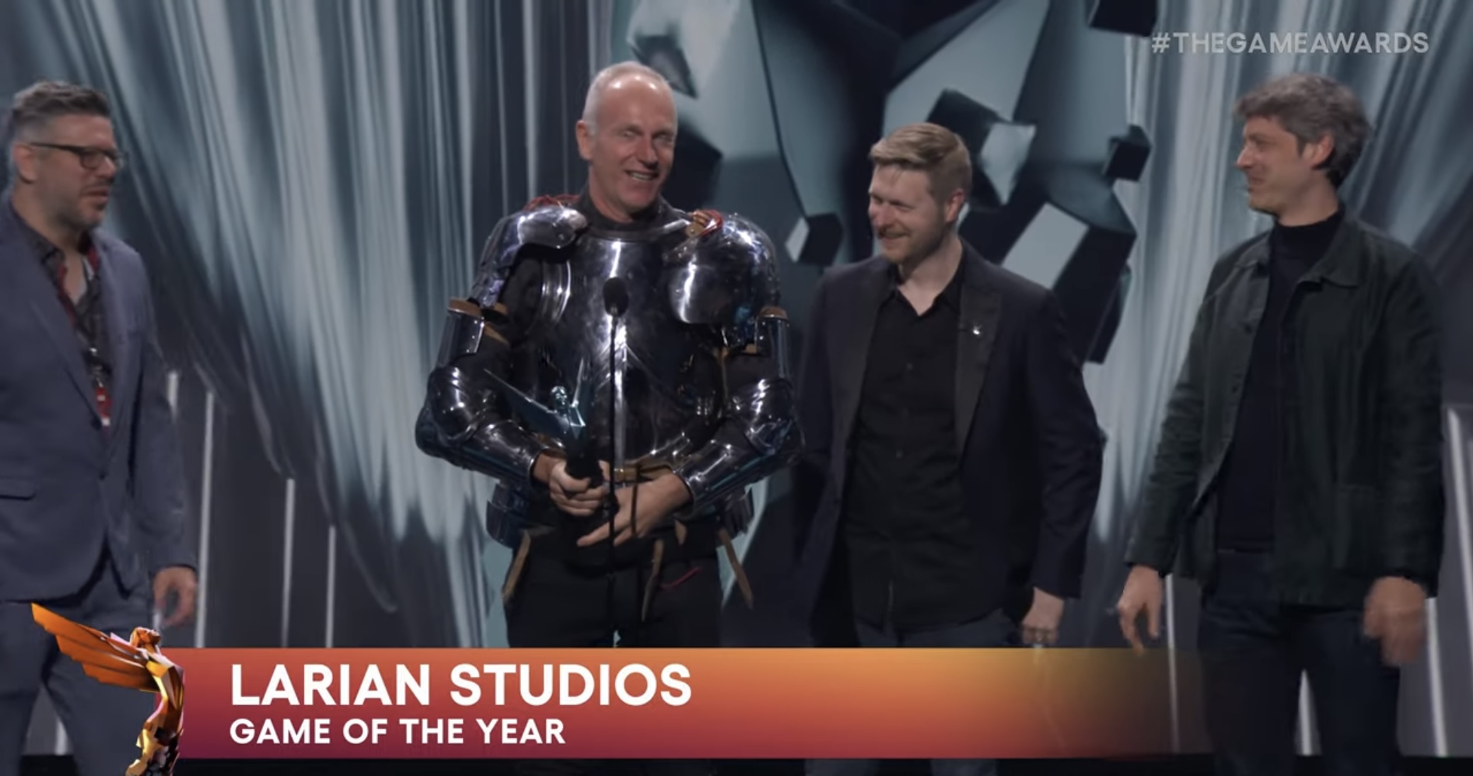 Larian CEO and founder Swen Vincke accepting the award for game of the year surrounded by developers.