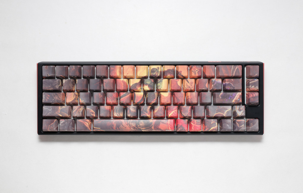 A top-down picture of the keyboard showcasing it's unique keycap design which features a scene of DOOM's player character, known by players as Doomguy, fighting demons.
