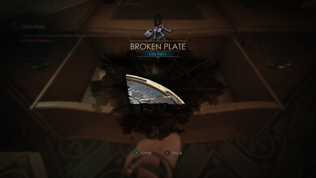 screenshot showing a typical screen when picking up an item to be used later on. Here we have a piece of broken plate that has been found in a drawer in yellow edging and grey with symbols carved onto it.