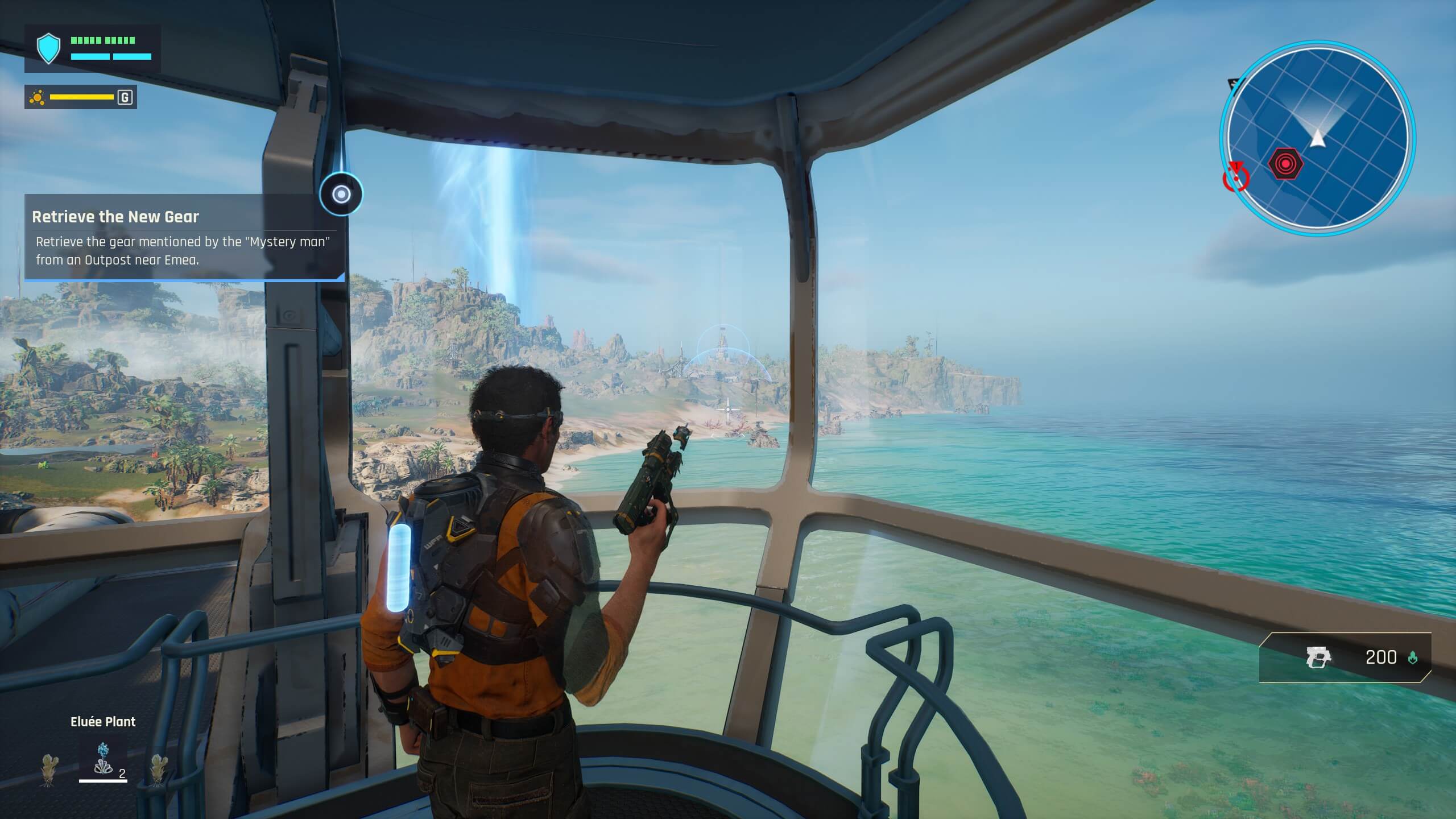 The player is shown within a viewport of a base, overlooking a vast shoreline. A large vertical beam can be observed in the distance going up and into the sky.