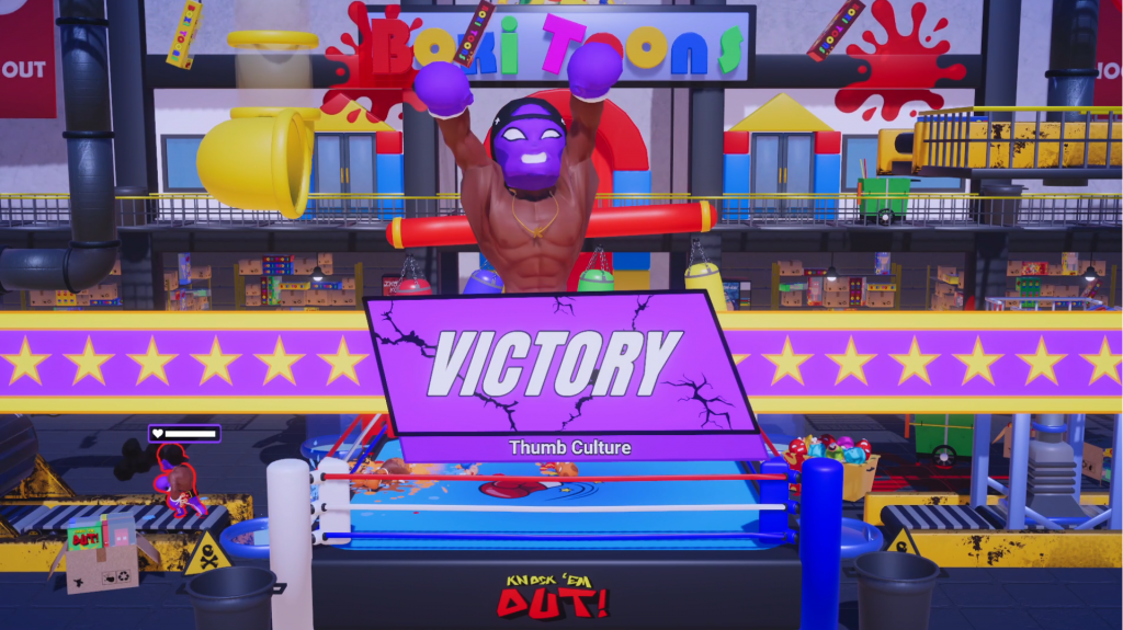 A character with a purple mask and boxing gloves celebrates with a big sign saying Victory.
