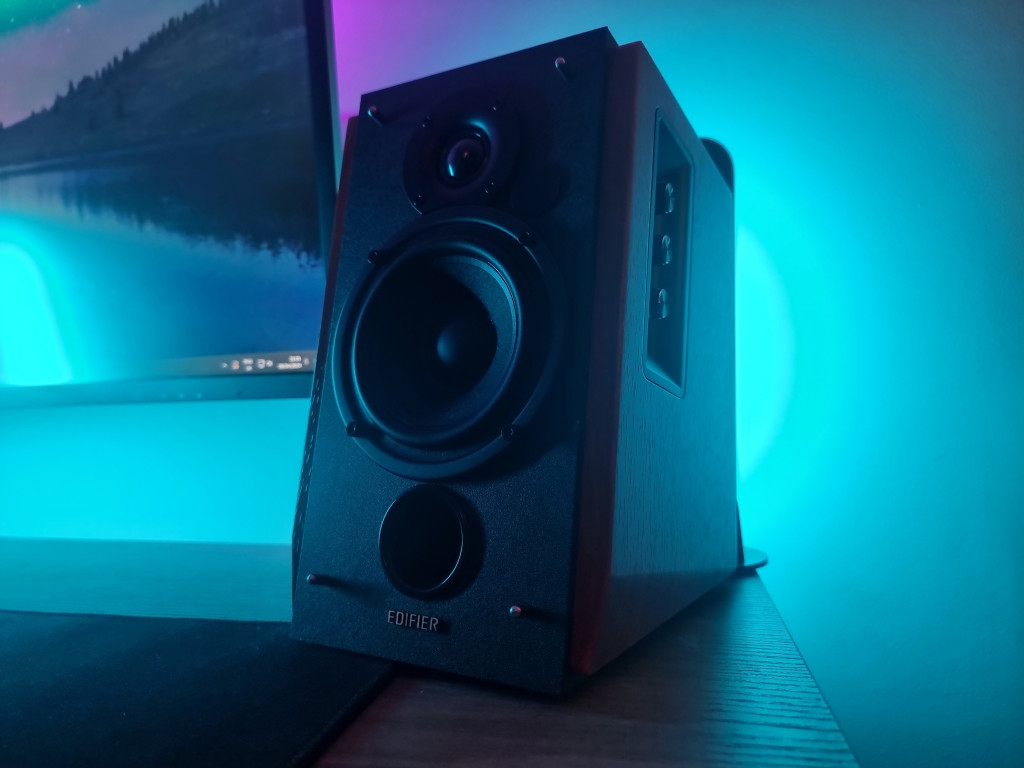 photo showing an Edifier speaker on my pc desk. it is lit in blue and purple.