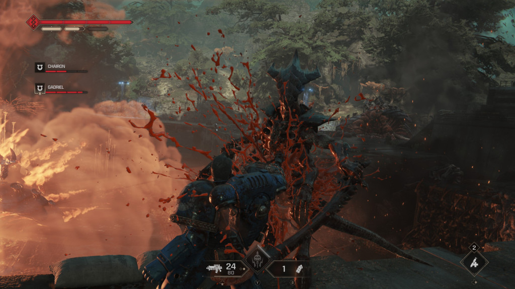 A character crouching behind cover in a fiery, chaotic gory battle scene.