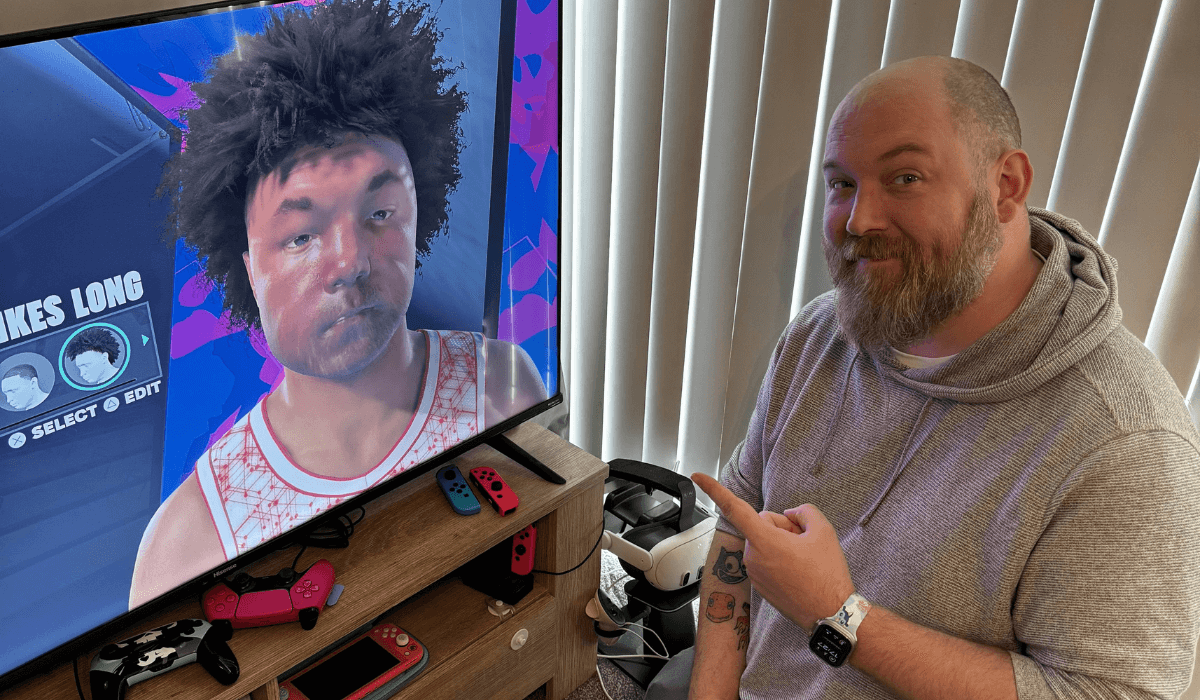 image showing Stu sat next to a screen showing his likeness when using the scanning app for NBA 2K25